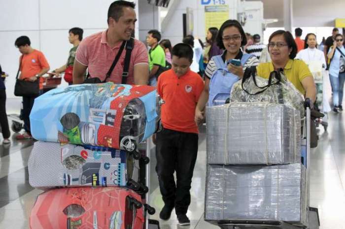 People wrapping their luggage tight at Manila's extortion-ridden airport